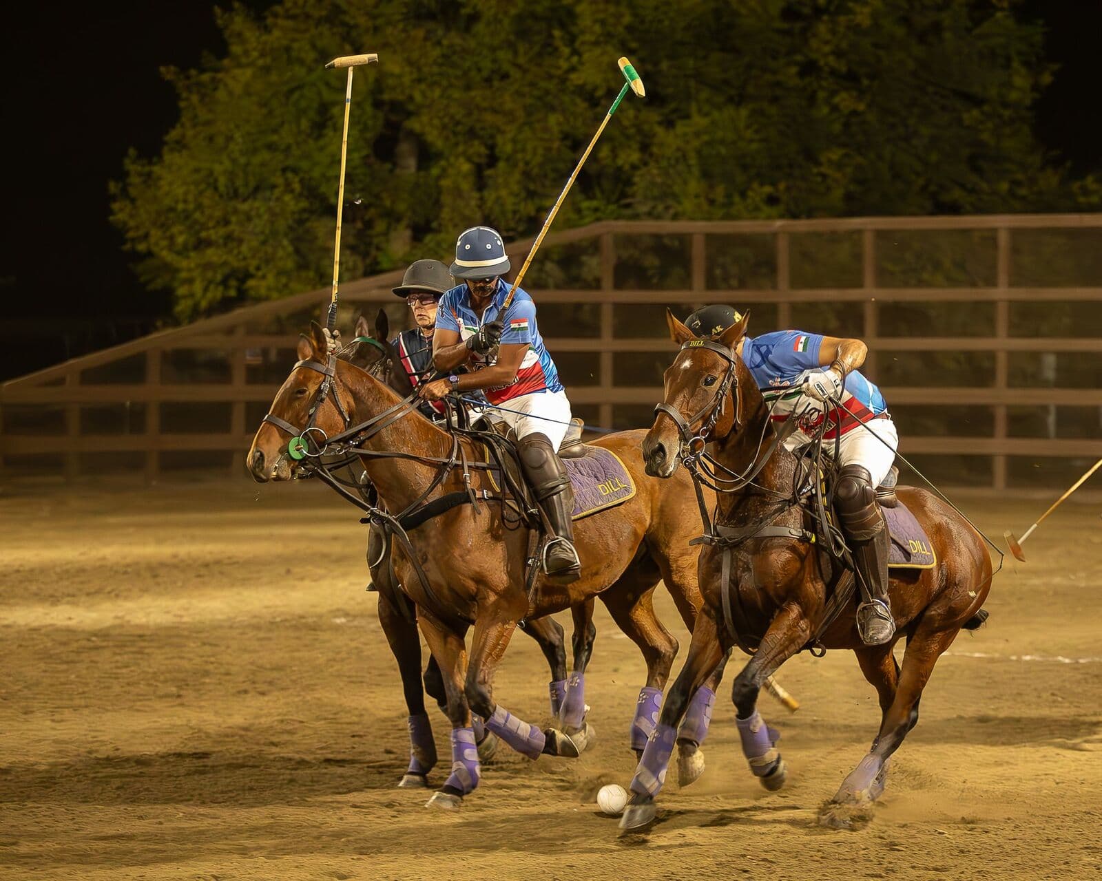 India and USA riders contest the ball under floodlights at Lakeside Polo Club